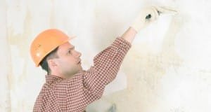 Drywall contractor repairing wall