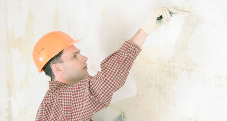 Drywall contractor repairing a wall